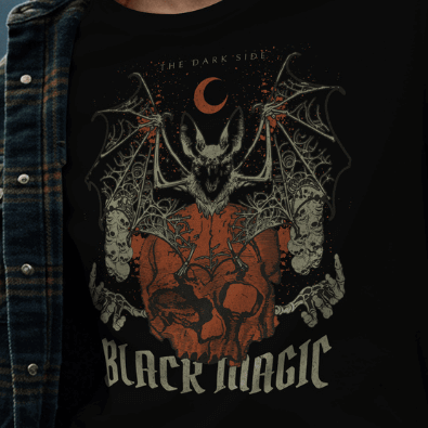 Close Up - Front View
Black t-shirt with a bat and skull design and 'Black Magic' text, worn by a person.