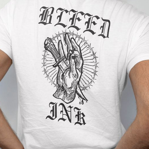 White t-shirt with black graphic design and 'BLEED INK' text on a plain background