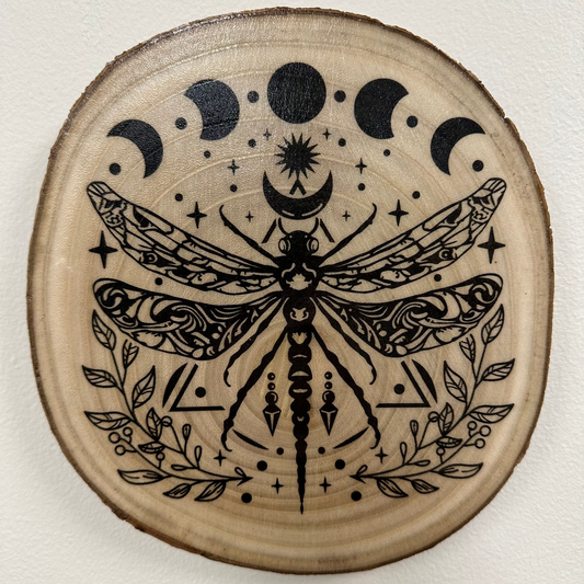 Close Up - Top View
Round, Burch, Wooden coaster with black dragonfly and moon phases design on a white background