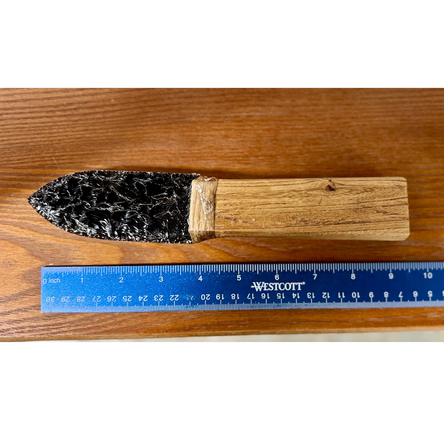 Close up Ruler Comparison
Obsidian knife on a wood surface.