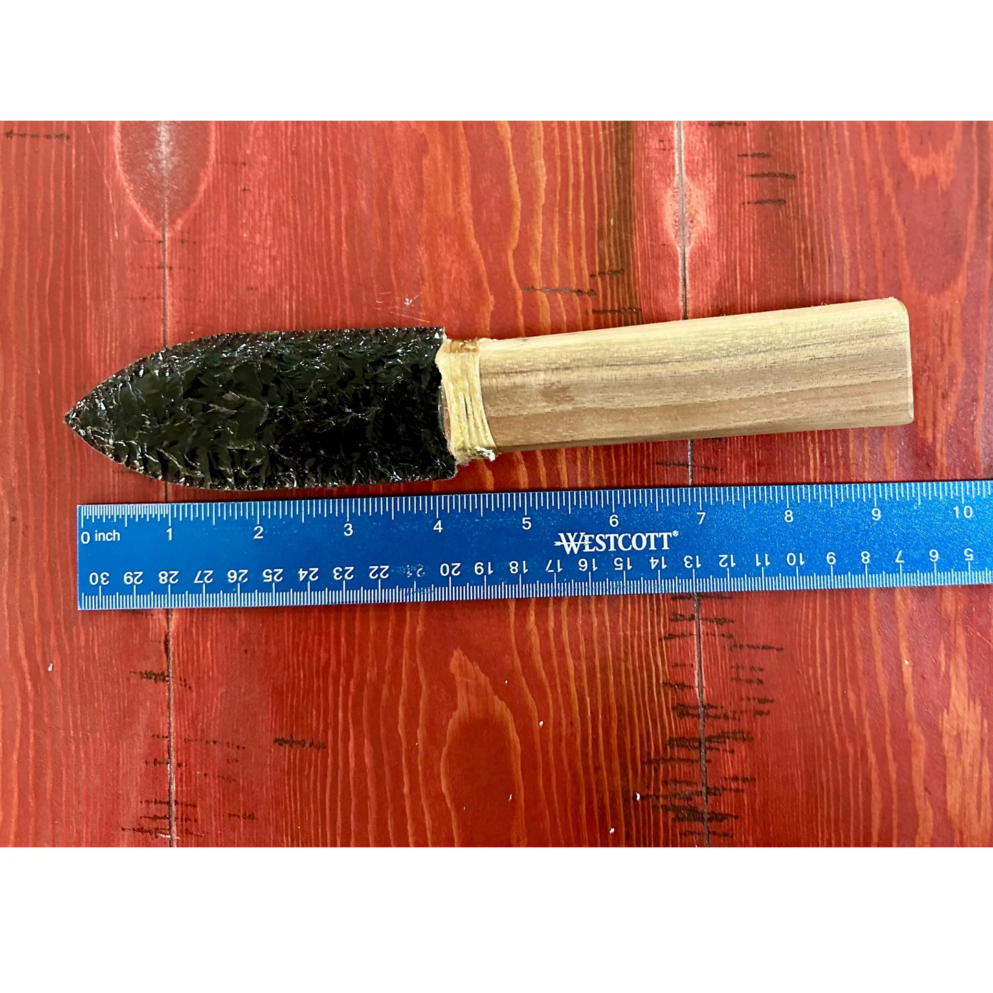 Close up
Hand-chipped obsidian knife with cherry wood handle. Blunted decorative display piece. Ancient craftsmanship meets natural elegance. Unique collector's item. Ruler for measurement