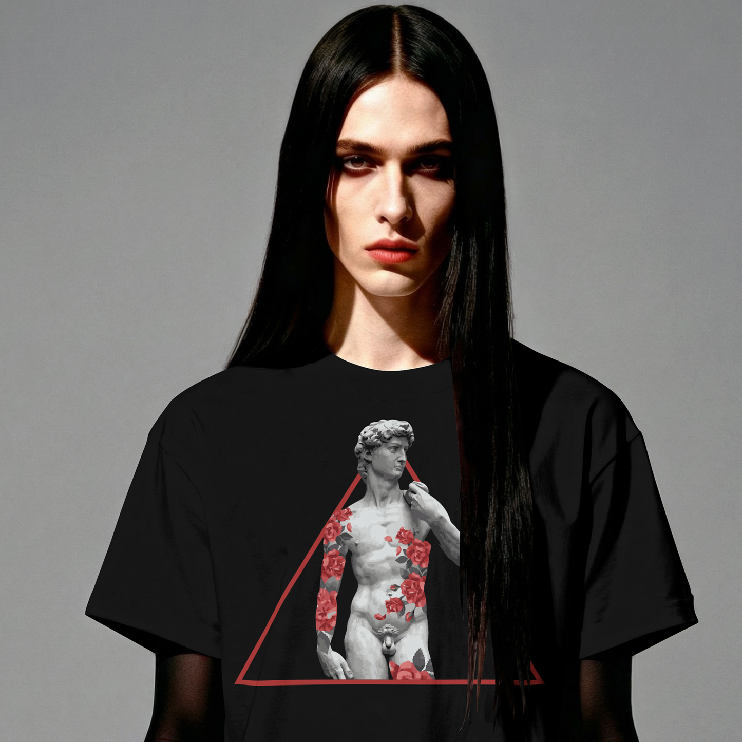 Person wearing a black t-shirt with a graphic design on a gray background