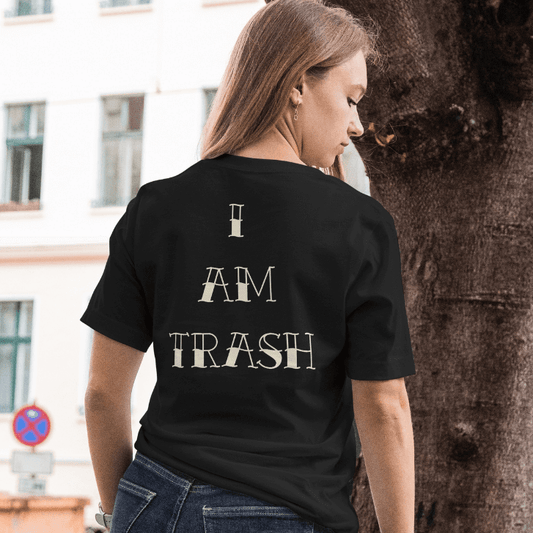 Back View worn by model.
Person wearing a black t-shirt with 'I AM TRASH' text on the back, standing outdoors.