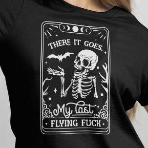 Close Up Front View
Woman wearing a black t-shirt with graphic design and text, "There it goes my last flying fuck" taking a selfie against a plain background