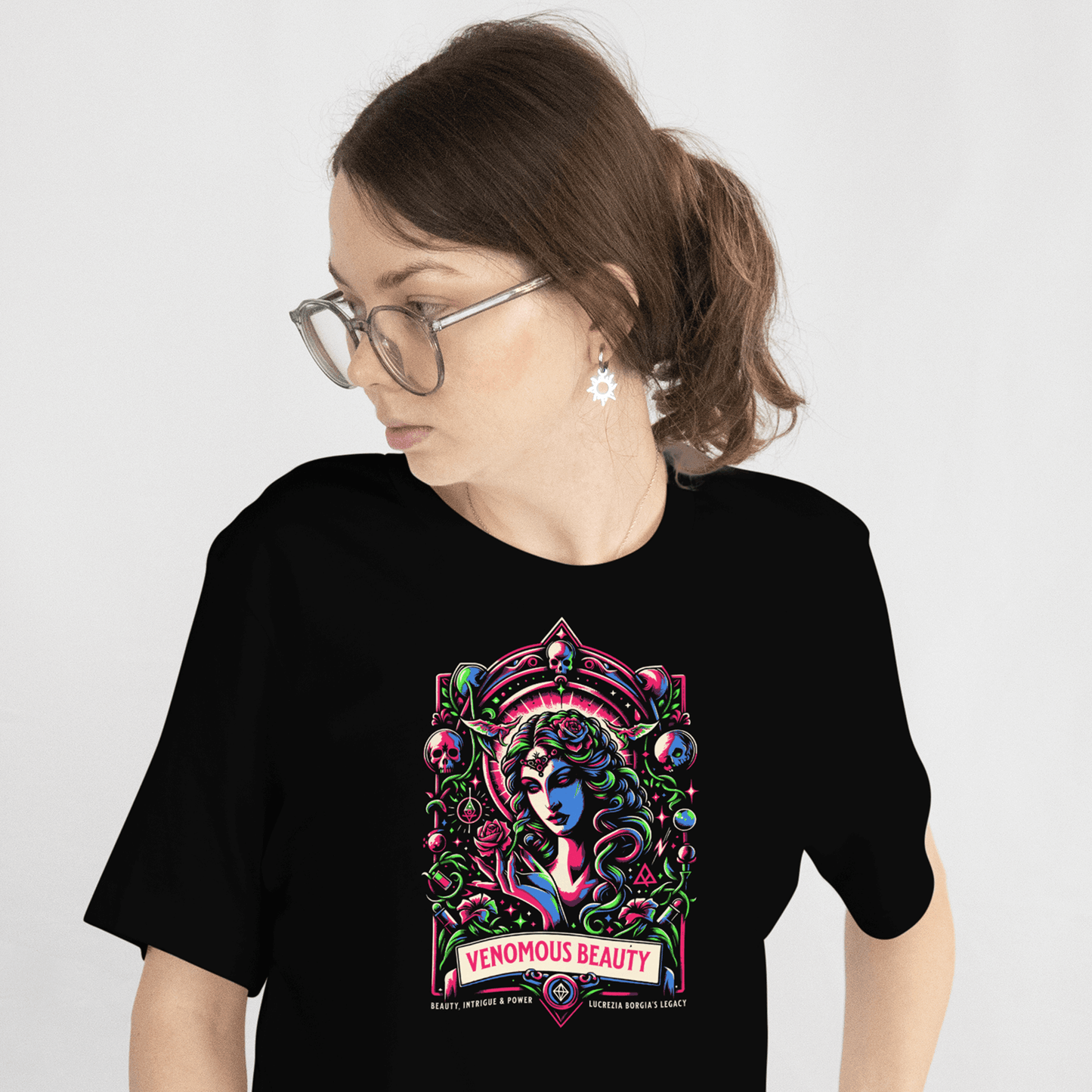 Person wearing a black t-shirt with a colorful graphic design on a plain background