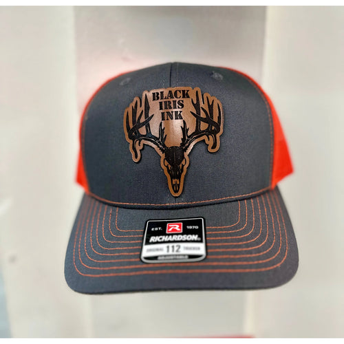 Close up
Heather gray and neon orange trucker hat with genuine leather deer skull patch on front panel

