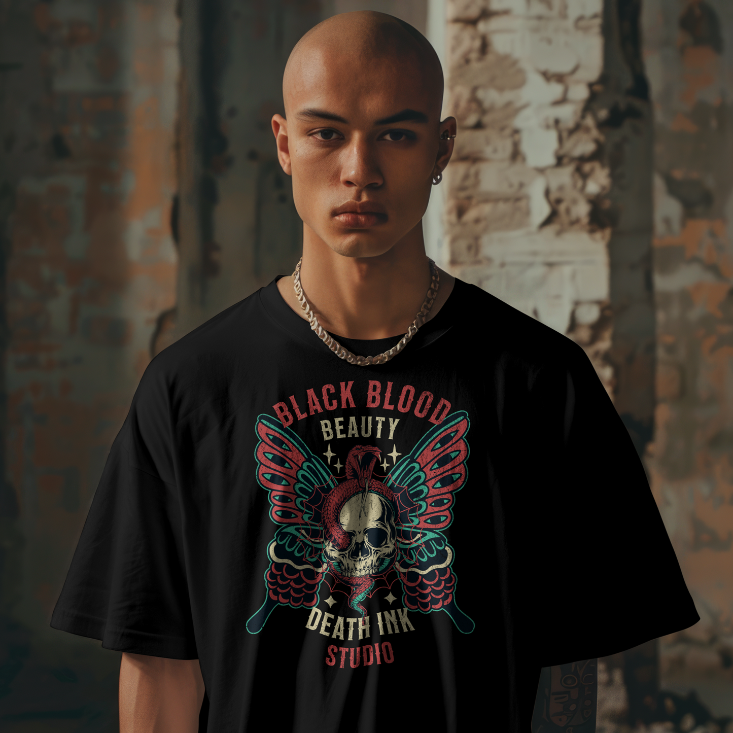Person wearing a black t-shirt with a graphic design in an urban setting