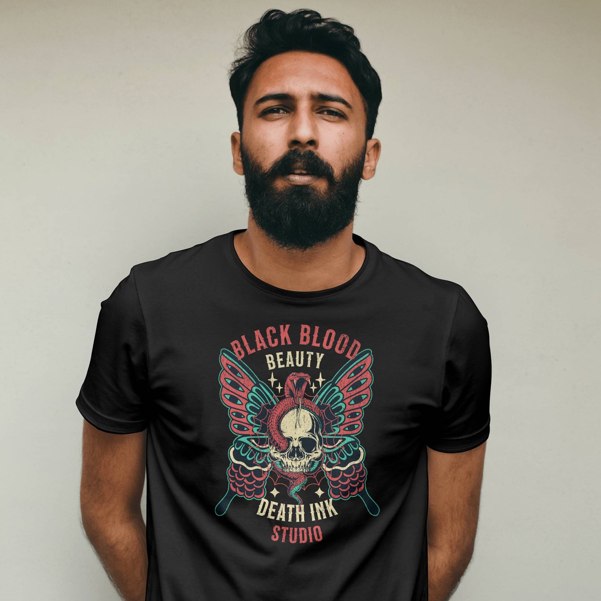 Man wearing a black t-shirt with a graphic design against a plain background