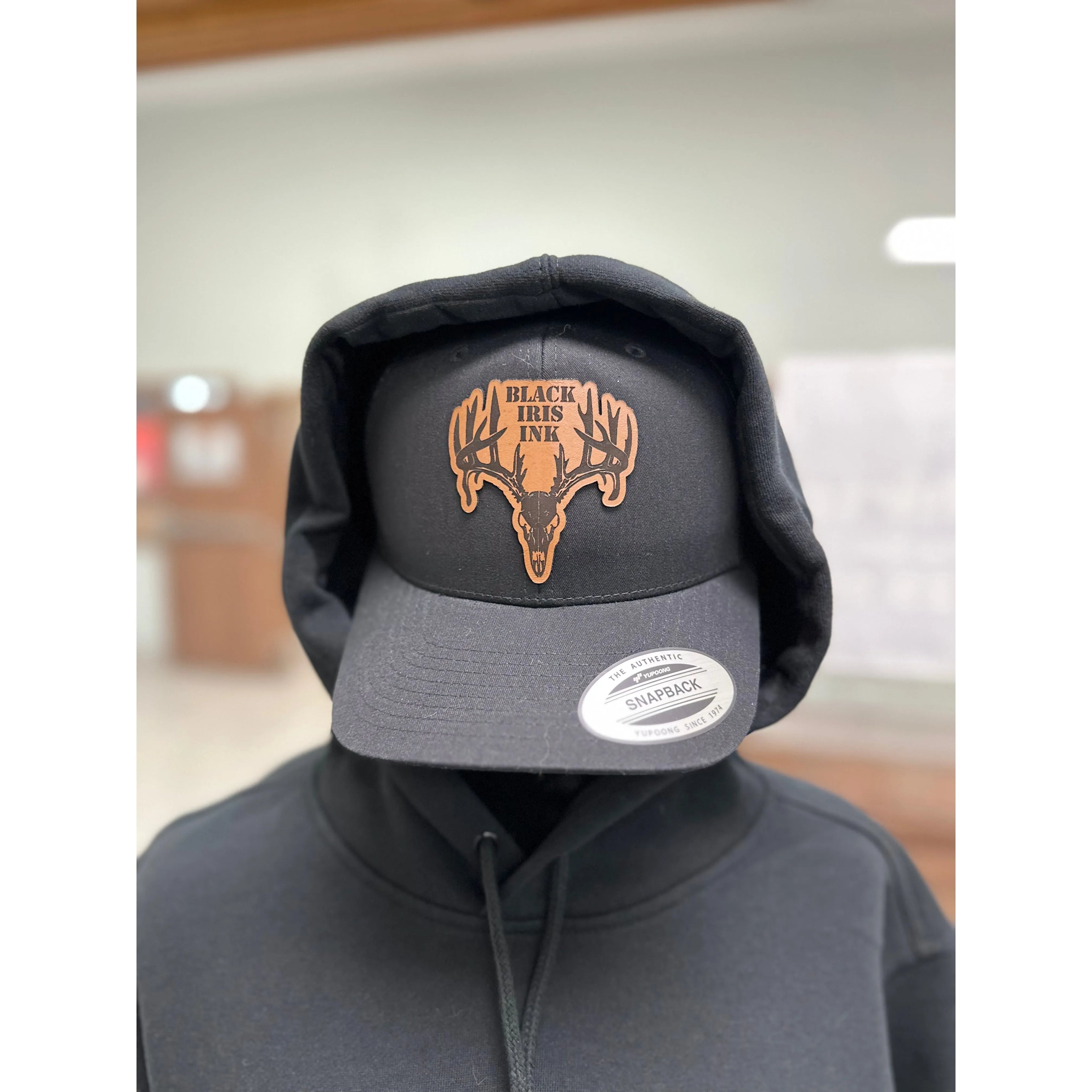 Black hat with Deer, leather patch in the center