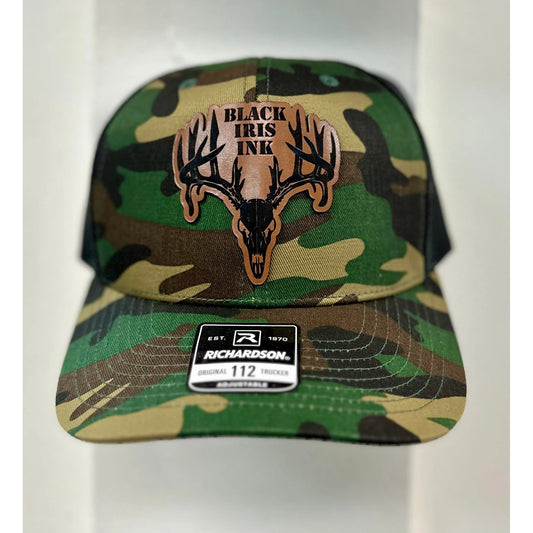 Close up
Camoflage hat with a deer skull,  leather patch in the center.