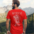 Red Bleed Ink T-Shirt Tattoo Inspired featuring bold artwork on the back of a red shirt against a mountain backdrop.