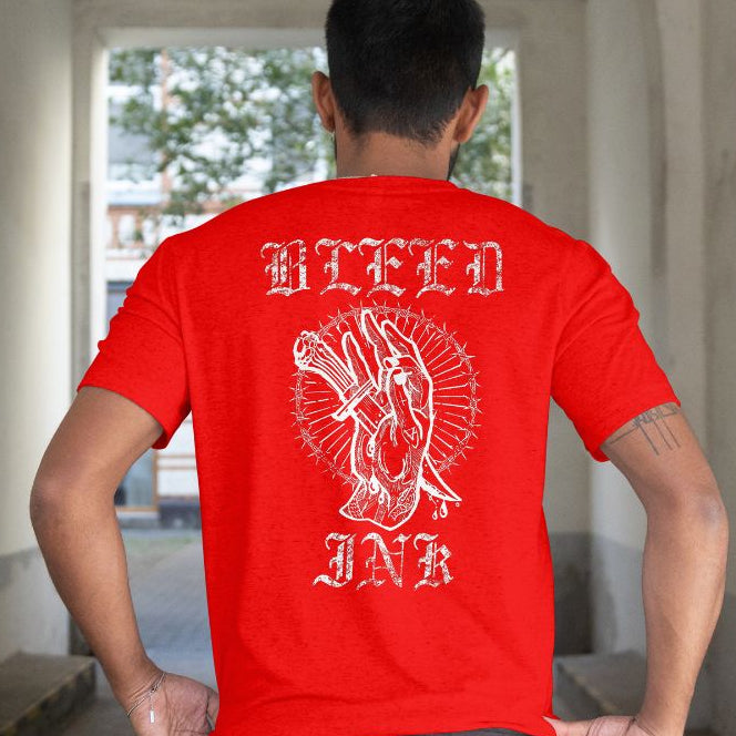 Back View
Person wearing a red t-shirt with white graphic design and text, 'Bleed Ink' standing in an indoor setting.