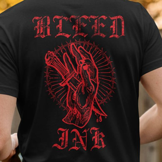 Close up back view
Black t-shirt with red graphic design and text on a blurred background