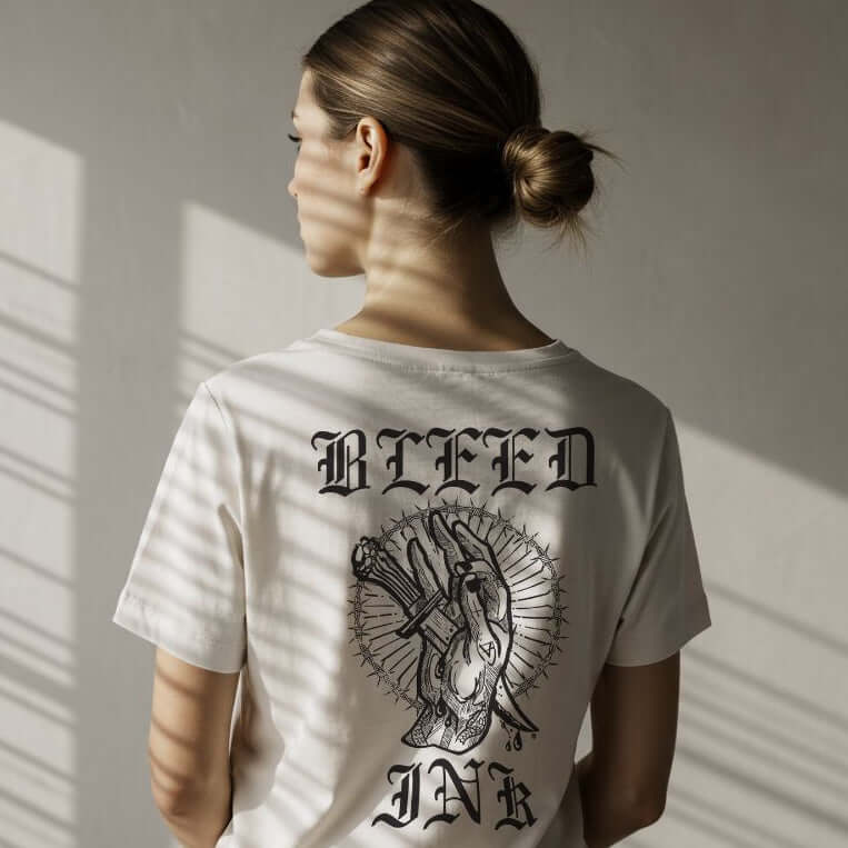 Close up Person wearing a White tattoo inspired graphic tee