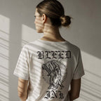 Close up Person wearing a White tattoo inspired graphic tee