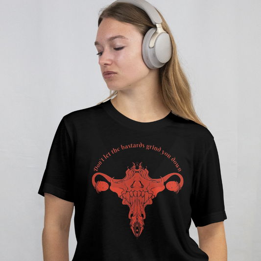 Front View on a model
Person wearing a black t-shirt with a red graphic and text, listening to music with headphones.