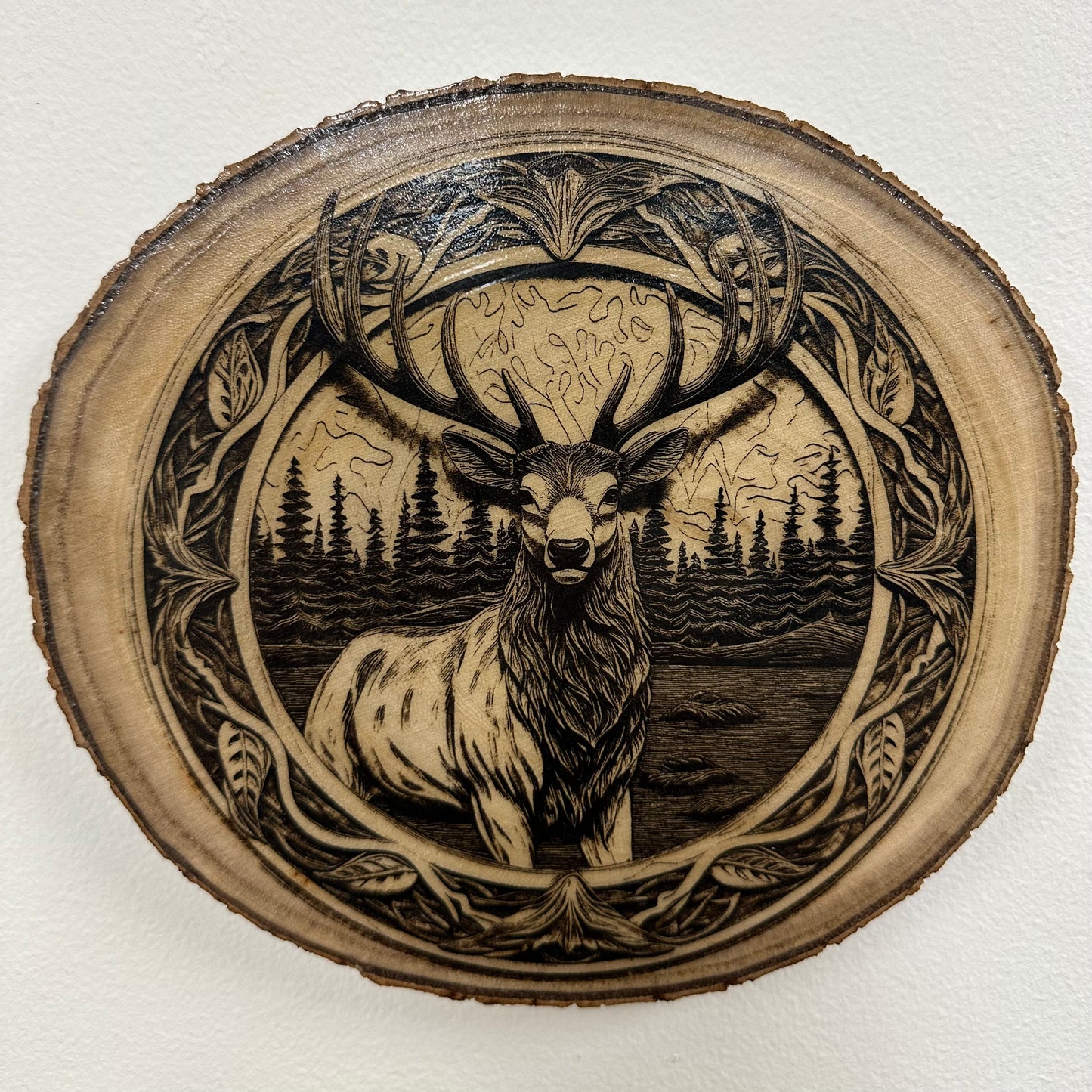 Close Up - Top View
Rustic round wooden Burch, plaque with an engraved Elk and nature scene on a white background