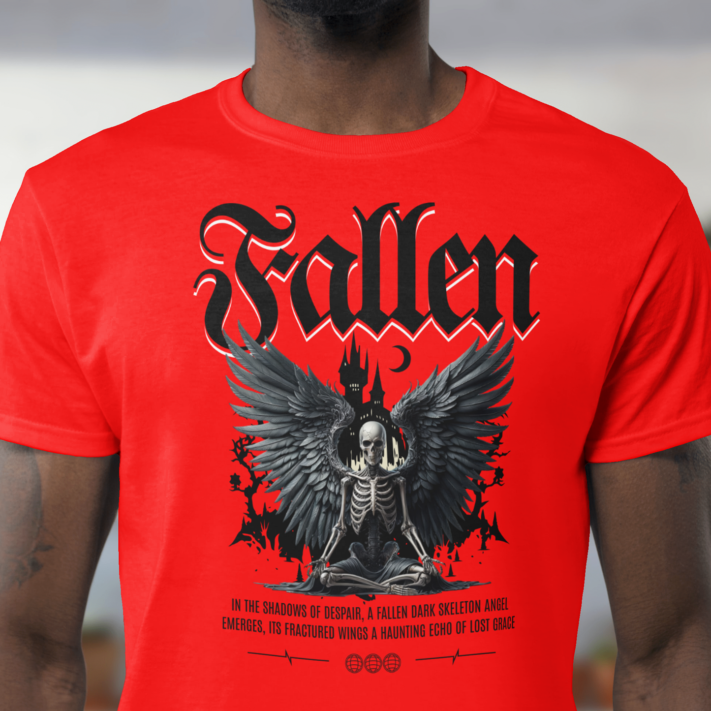 Red t-shirt with 'Fallen' graphic design featuring a skeleton and wings, worn by a person.