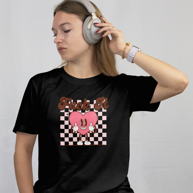 Front View- Worn by a model
Person wearing a black t-shirt with a graphic design "Fuck It" while listening to music with headphones on a plain background