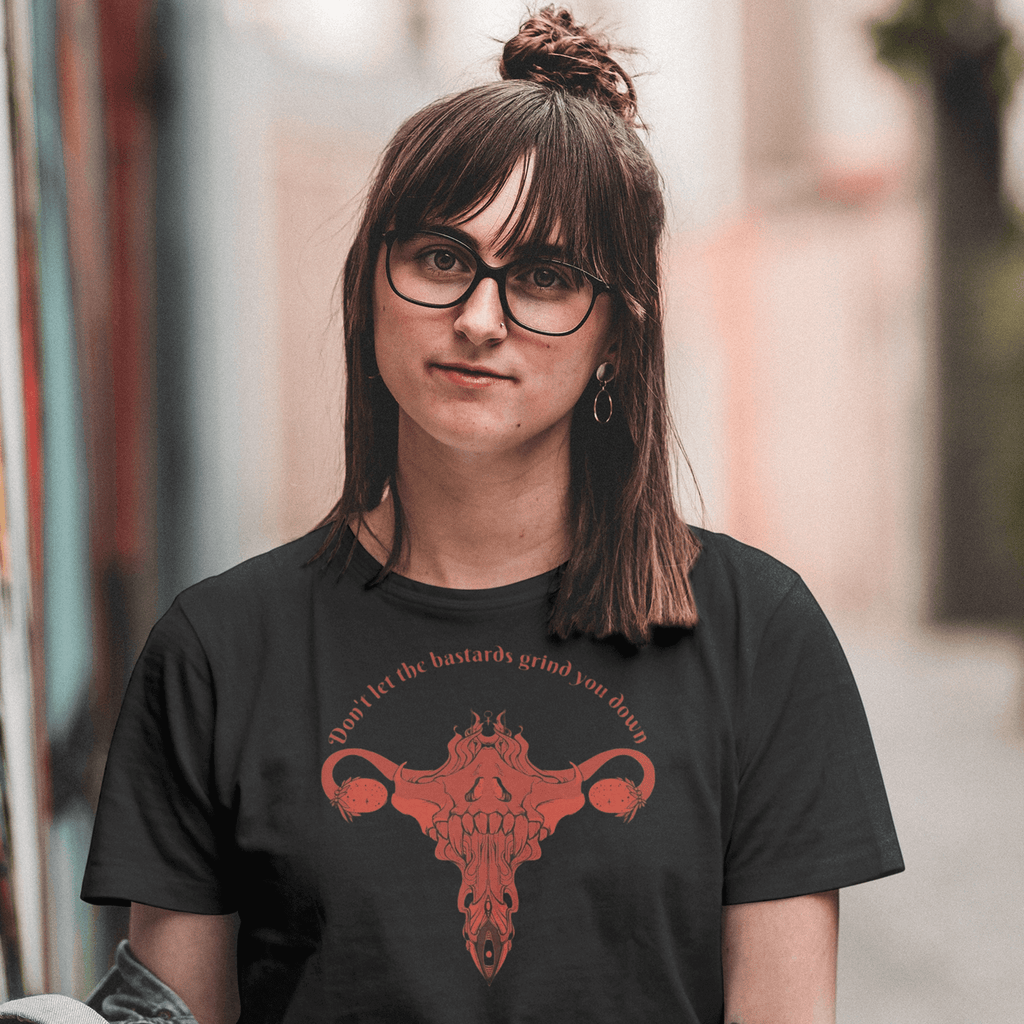 Person wearing a Don't Let Them Grind You Down Black Cotton T-Shirt