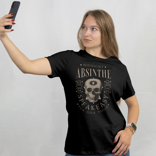Front View
Woman wearing a black t-shirt with a skull design Absinthe and text, taking a selfie against a plain background.