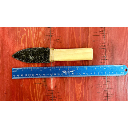 Hand made Obsidian knife  with wooden handle and stone head next to a ruler on a wooden surface