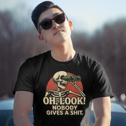 Person wearing a black t-shirt with a skeleton design and text, sitting outdoors.