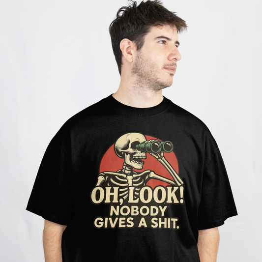 Front View
Person wearing a black t-shirt with a skeleton design and text 'Oh, look nobody gives a shit' on a white background.
