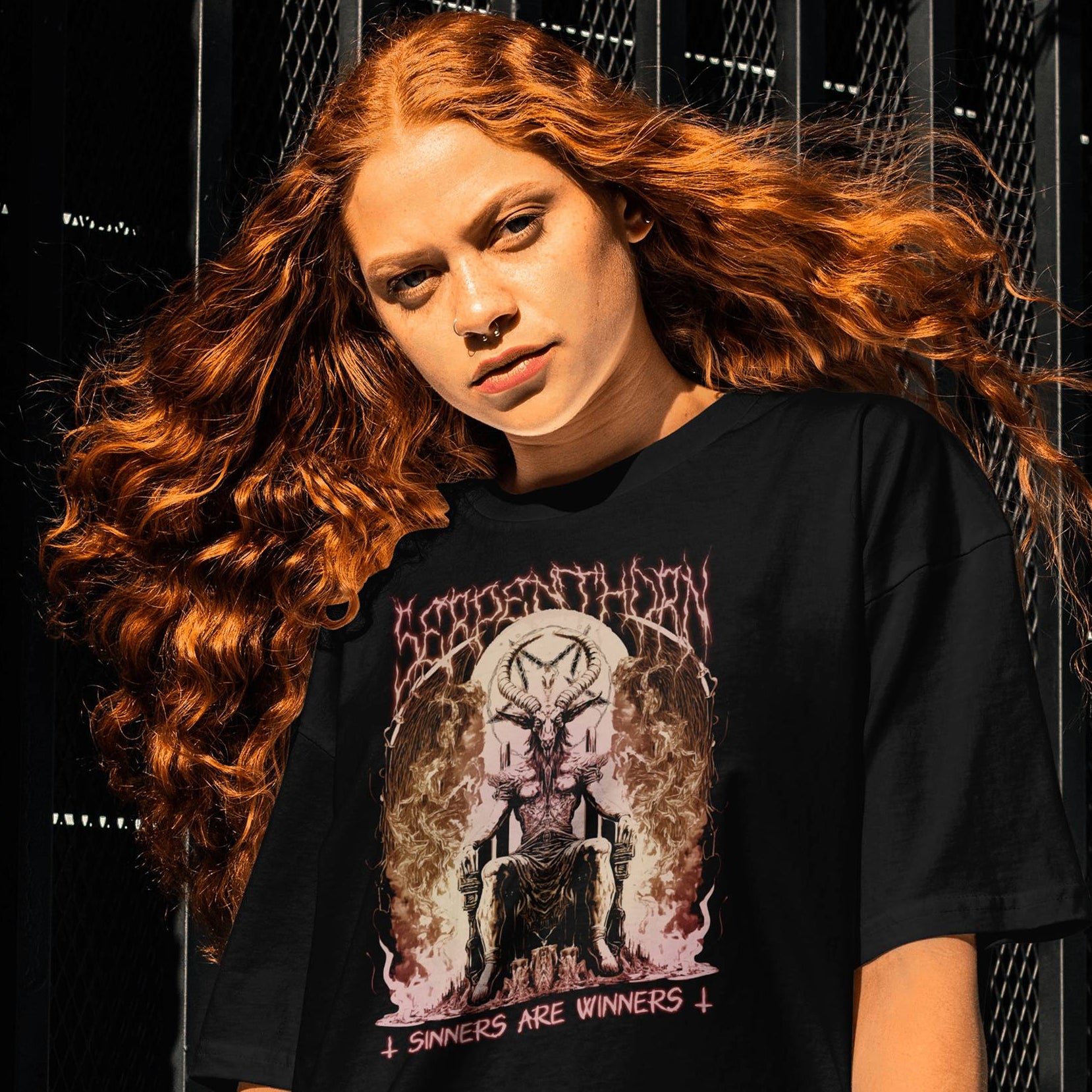 Person wearing a black t-shirt with graphic design against a dark  background Serpenthron Design