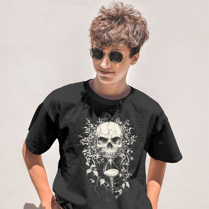Person wearing a black t-shirt with a skull design on a plain background