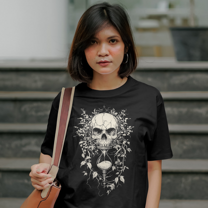 Woman wearing a black t-shirt with a skull design, standing outdoors.