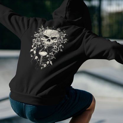 Back View
Person wearing a black hoodie with a skull design outdoors
