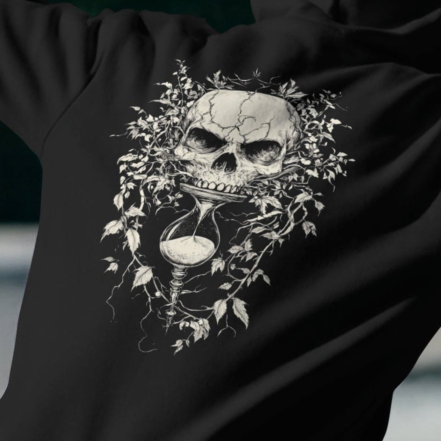 Close Up
Black hoodie with a skull and hourglass design on a dark background