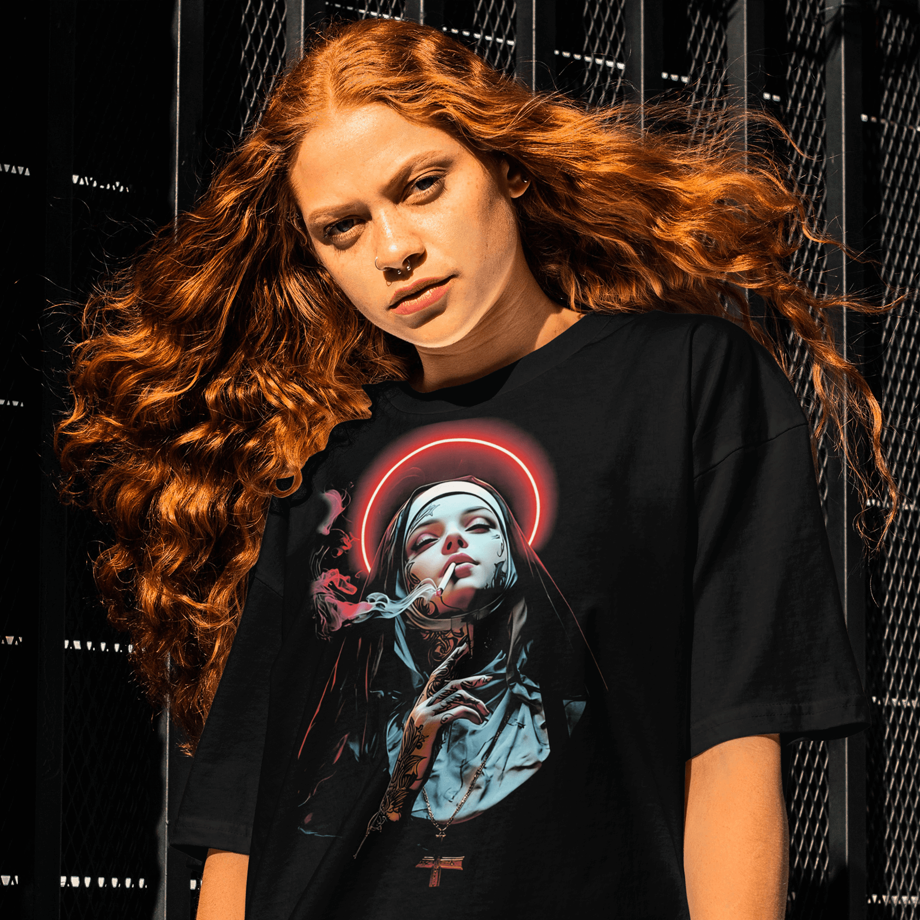 Person wearing a black t-shirt with a graphic design against a dark background