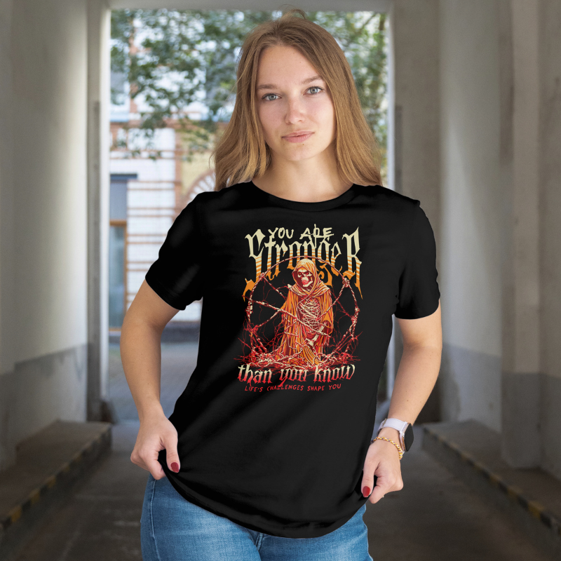 Person wearing a black t-shirt with a graphic design 'You Are Stronger' and text.