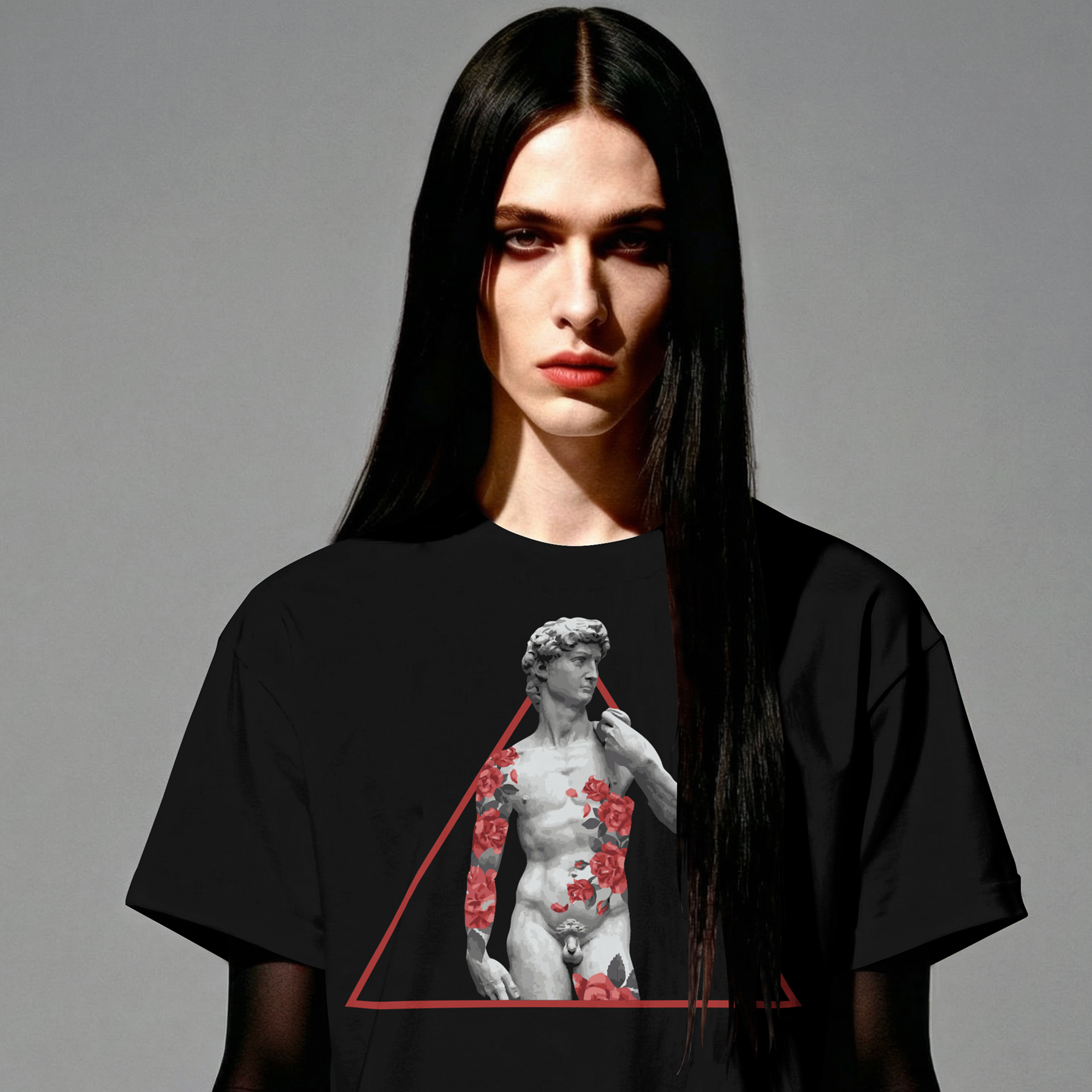 Person wearing a black t-shirt with a graphic design on a gray background