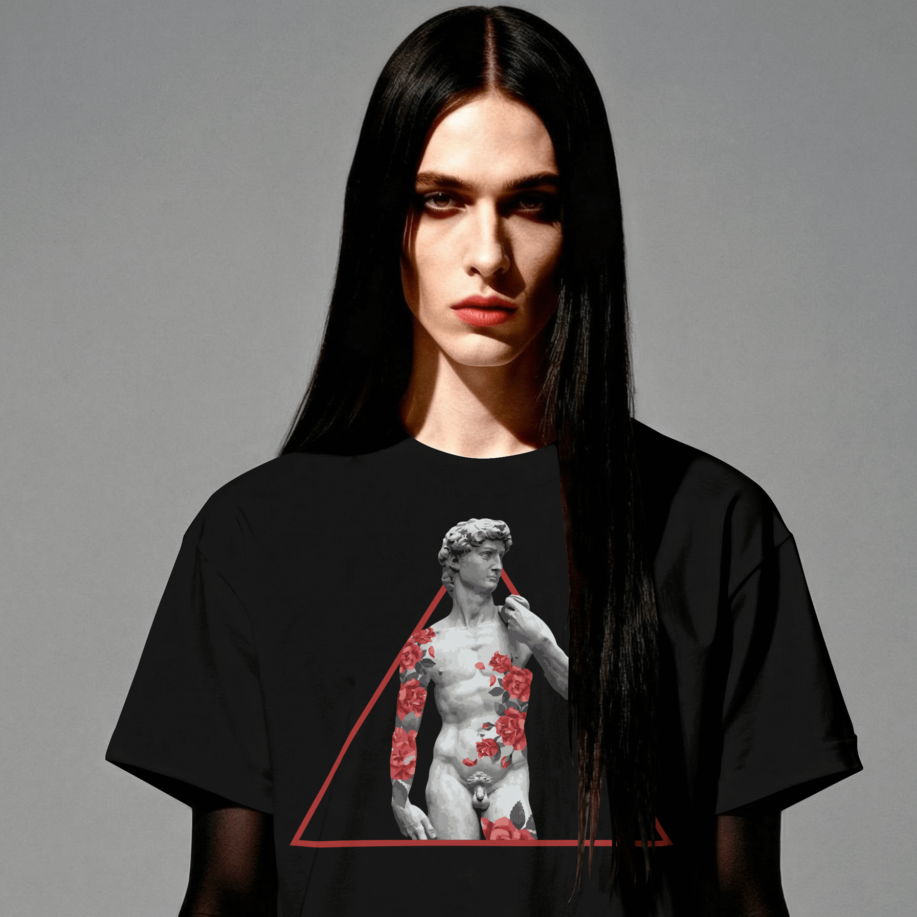 Person wearing a black t-shirt with a graphic design on a gray background