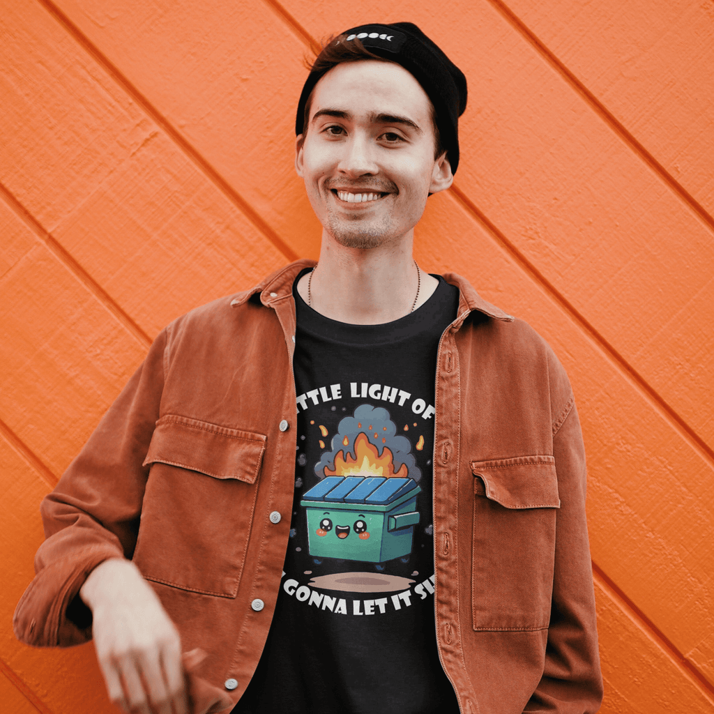 Person wearing a black t-shirt with a graphic design and an orange jacket, standing against an orange wall.