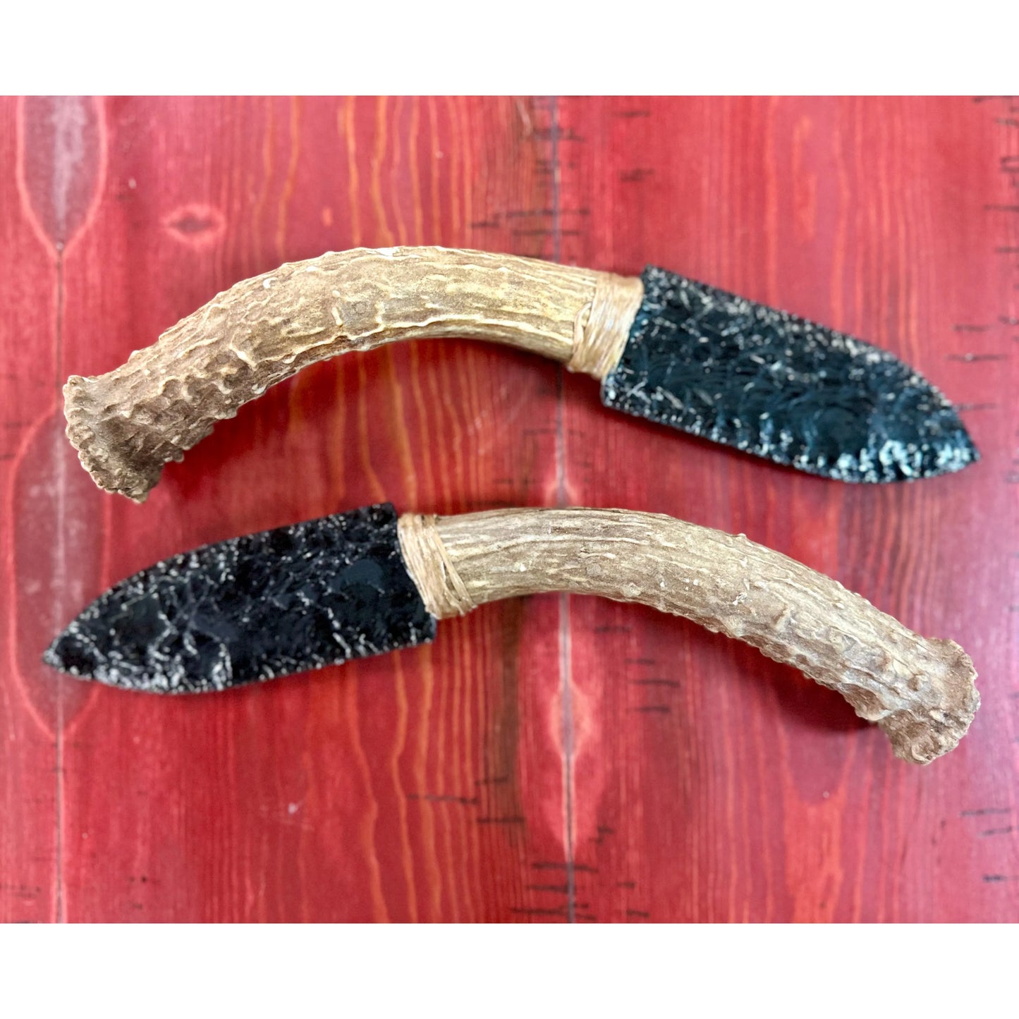 Twin Set Top View
Twin Obsidian Knives Lying on a wooden surface. 