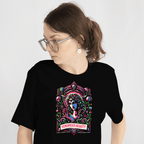 Person wearing a black t-shirt with a colorful graphic design on a plain background