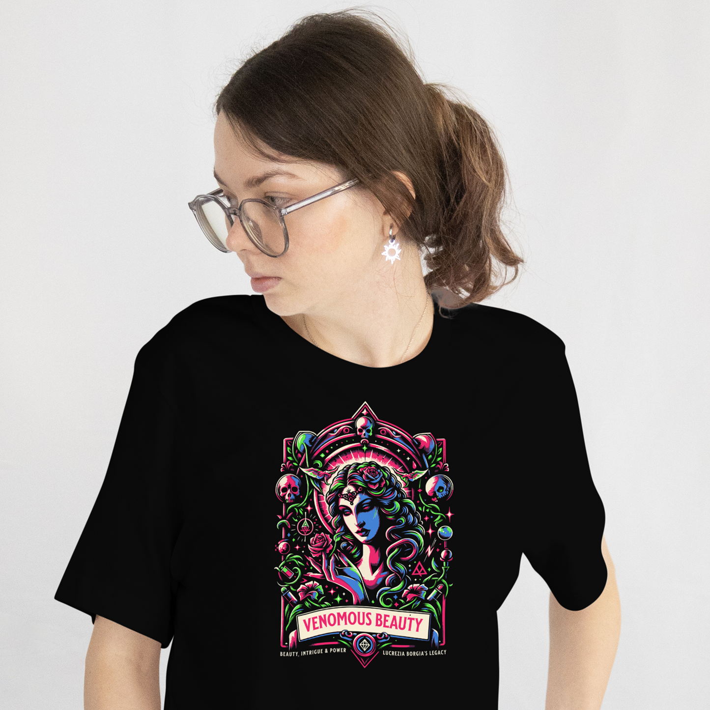 Person wearing a black t-shirt with a colorful graphic design on a plain background