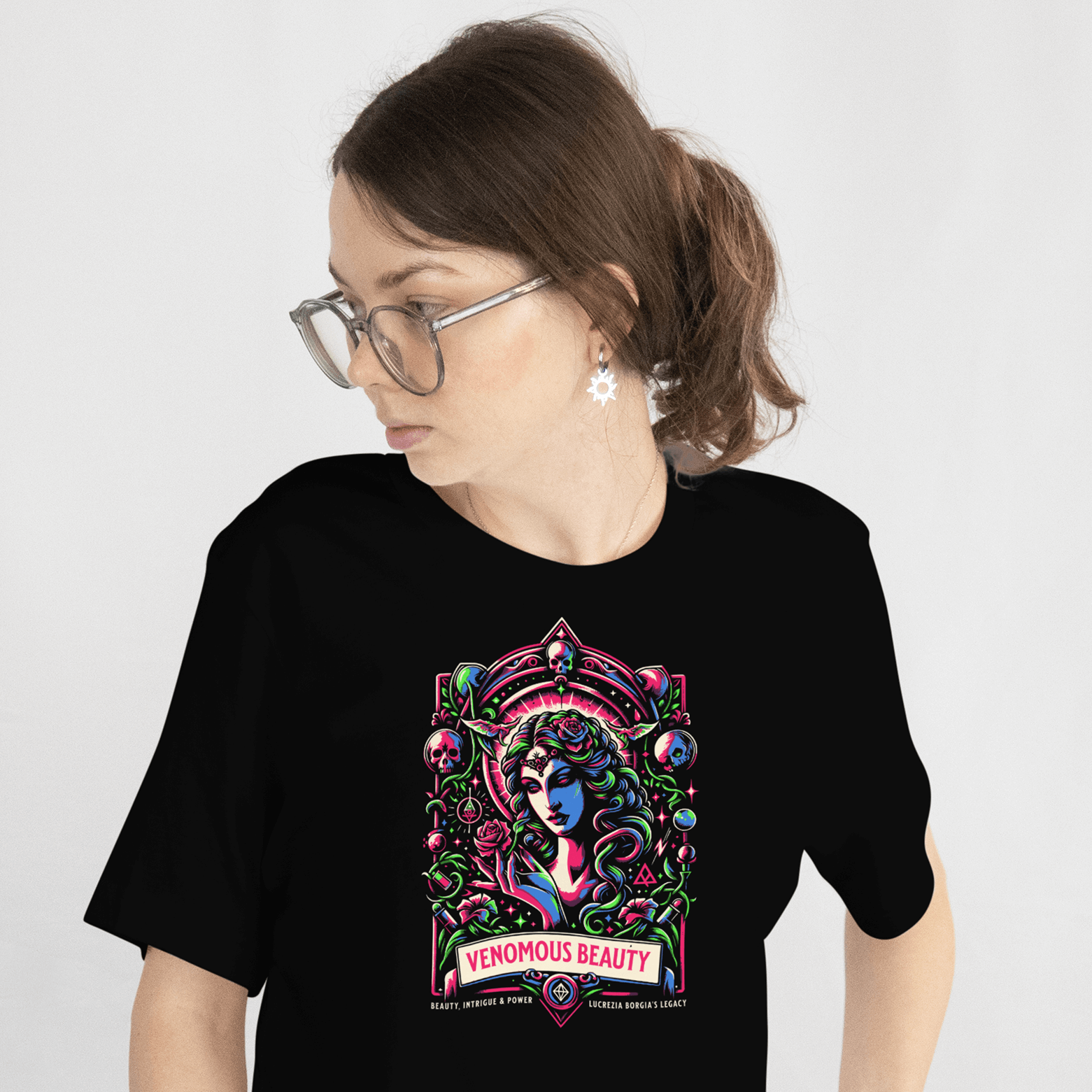 Person wearing a black t-shirt with a colorful graphic design on a plain background