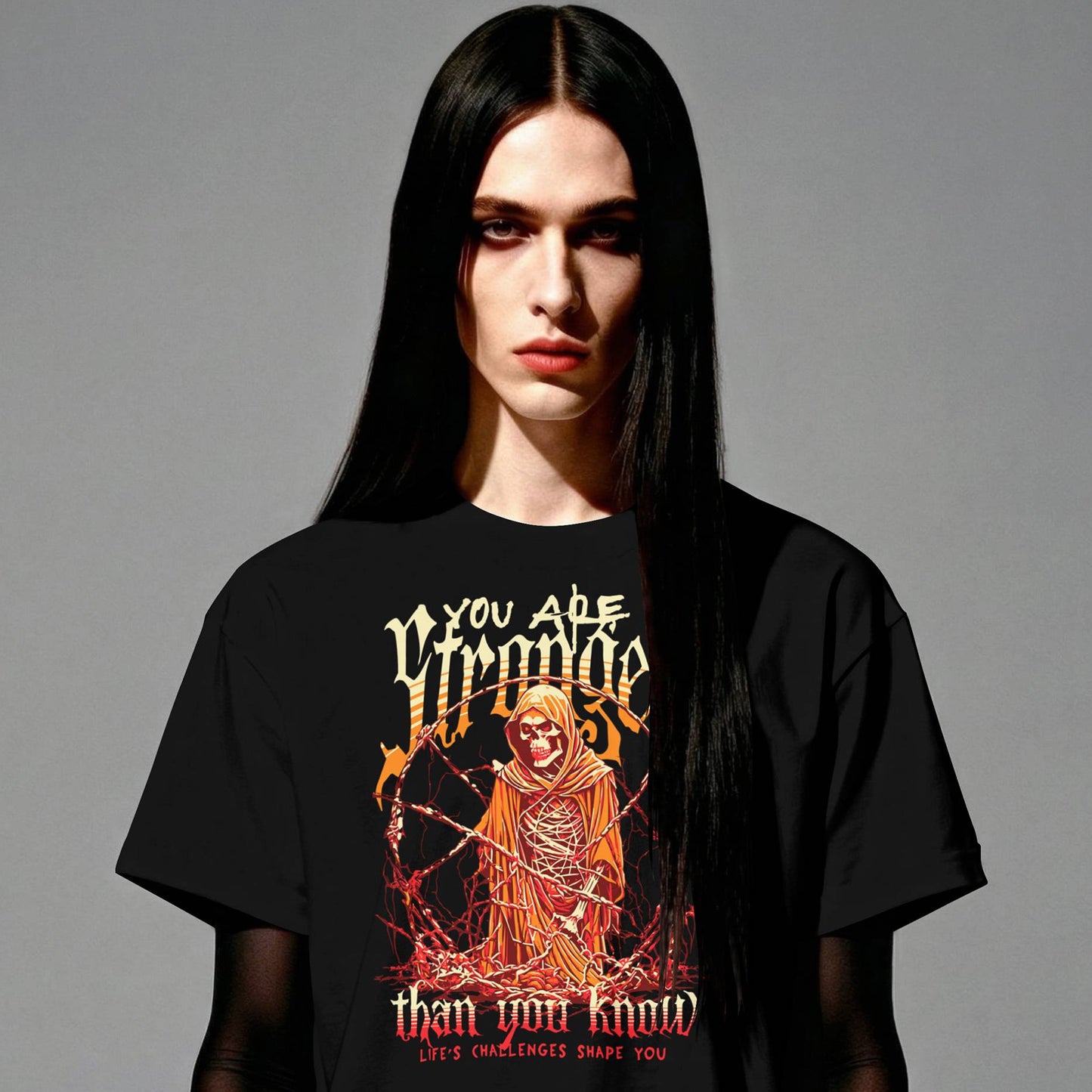 Person wearing a black t-shirt with a graphic design and text on a gray background