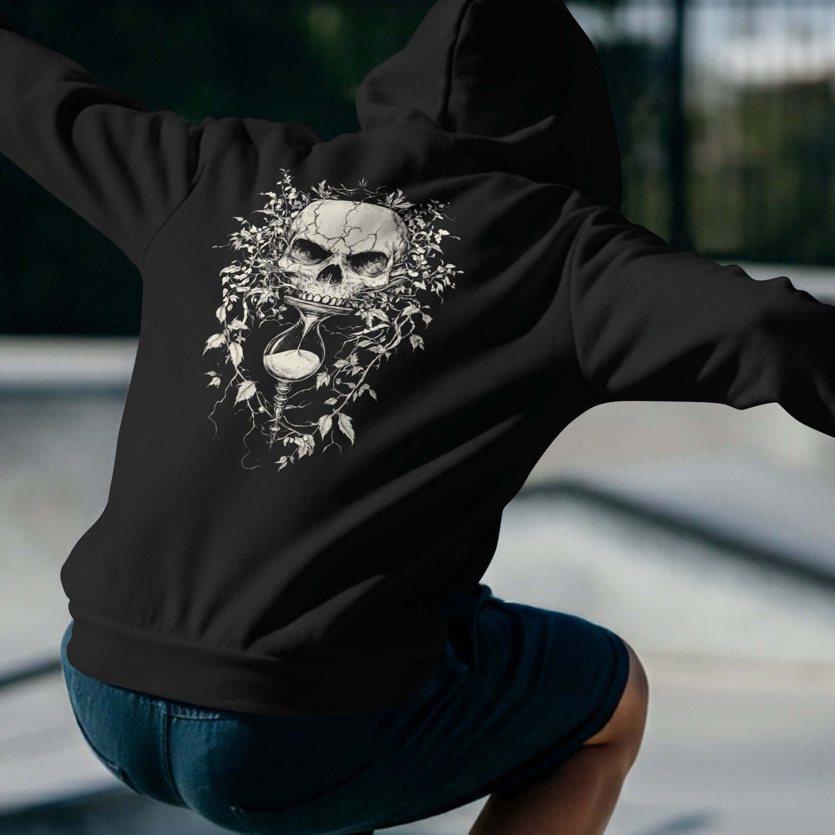 Man wearing a heavyweight skull-hourglass hoodie with a unique skull design, showcasing comfort and style.